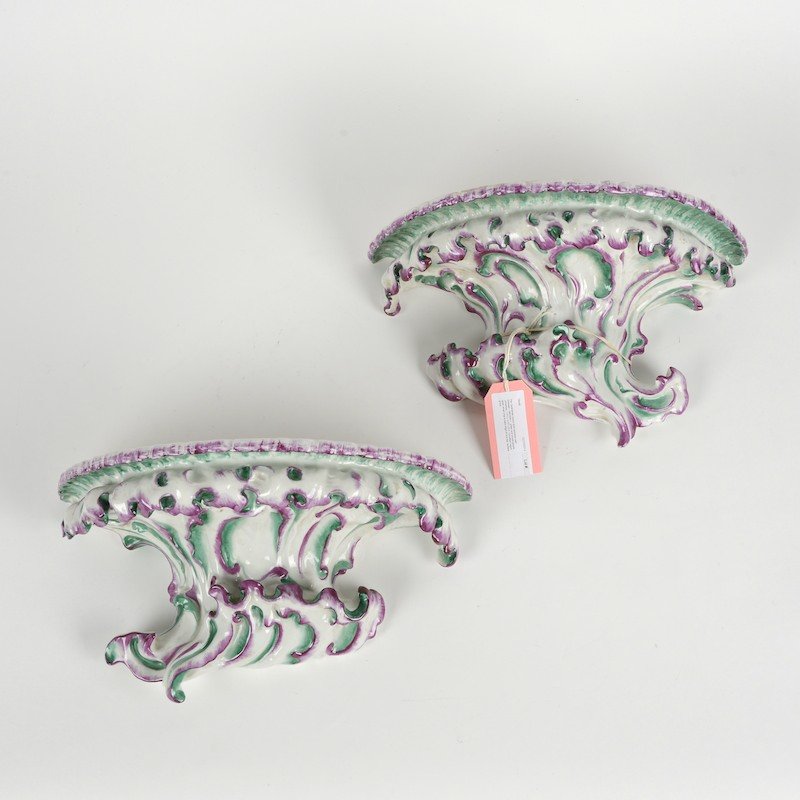 Pair Continental rococo style porcelain wall brackets: Pair Continental rococo style porcelain wall brackets, 19th/20th c., green and purple glazes, unmarked, 7.5"h x 13.5"l x 6"d