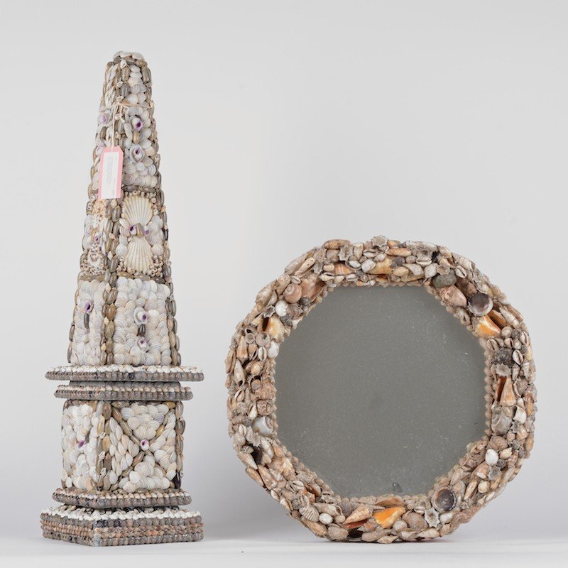 Grotto style shell encrusted obelisk and mirror: Grotto style shell encrusted obelisk and mirror, 20th c., (2) pieces, 31"h x 8"squ. (obelisk), 19"dia. (mirror) Provenance: Sara Gilbane Interiors, NY