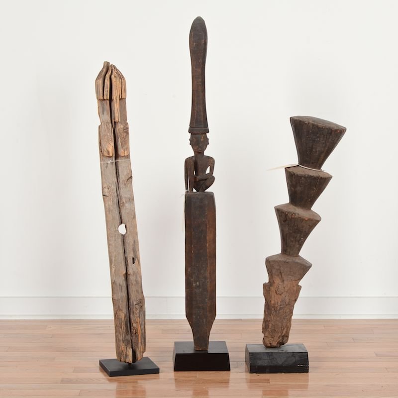 (3) African and Oceanic tribal wood carvings: (3) African and Oceanic tribal wood carvings, 20th c., one possibly a grave marker the other Nias, Indonesia, all mounted, largest: 34"h x 3.25"w x 3.5"d Provenance: From the Rona Family Collections, 