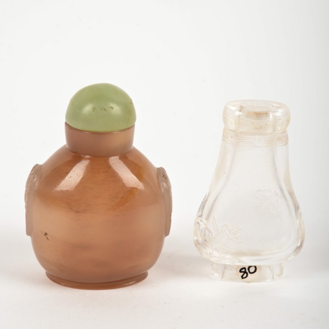 (2) Chinese hardstone snuff bottles: (2) Chinese hardstone snuff bottles, 19th/20th c., agate with jade cap and rock crystal (lacks traditional cap and dipper), 2.5"h x 1.75"w and 2.25"h x 1.25"w