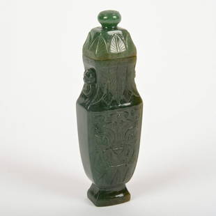 Chinese carved spinach jade urn and cover: Chinese carved spinach jade urn and cover, Qing Dynasty, decorated with taotie and stiff leaves, 5"h x 1.5"w