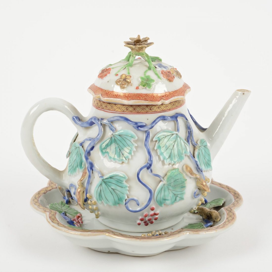 Nice Chinese Export teapot and stand: Nice Chinese Export teapot and stand, 19th c., grape vine and squirrel decoration in high relief, 6.25"h x 6.5"dia. (total)