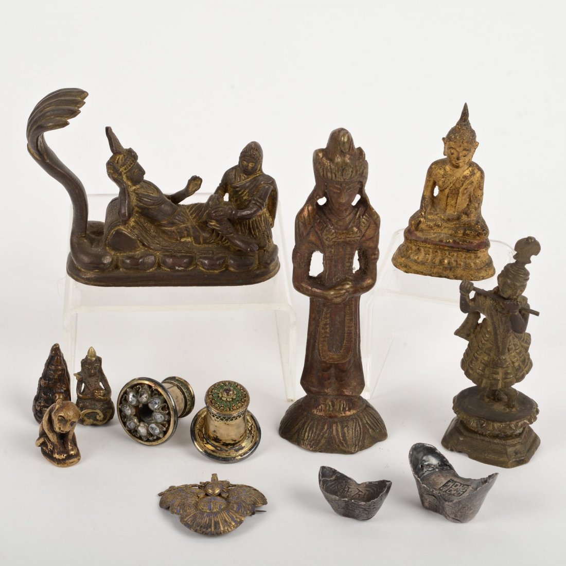 Group Chinese, Japanese, Southeast Asian metalware: Group Chinese, Japanese, Southeast Asian metalware, 19th/20th c., (12) pieces, incl. Chinese silver ingots, Buddhist statuary and stone mounted silver earrings, 5"h x 1.5"w x 1.25"d (largest), 1.25"h 