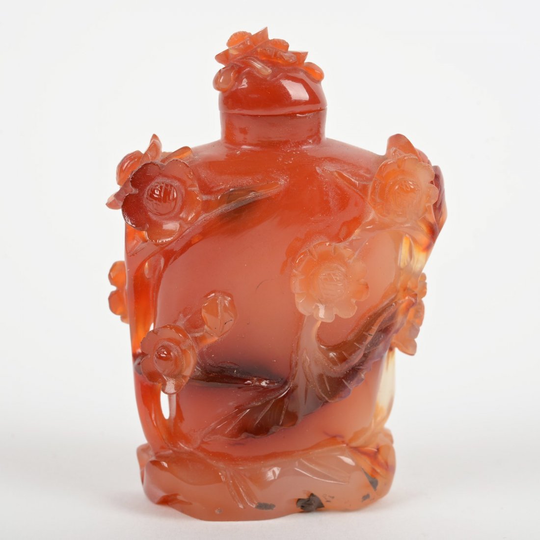 Chinese caved carnelian snuff bottle: Chinese caved carnelian snuff bottle, 19th/20th c., flowering branch decoration, 3"h x 2"w