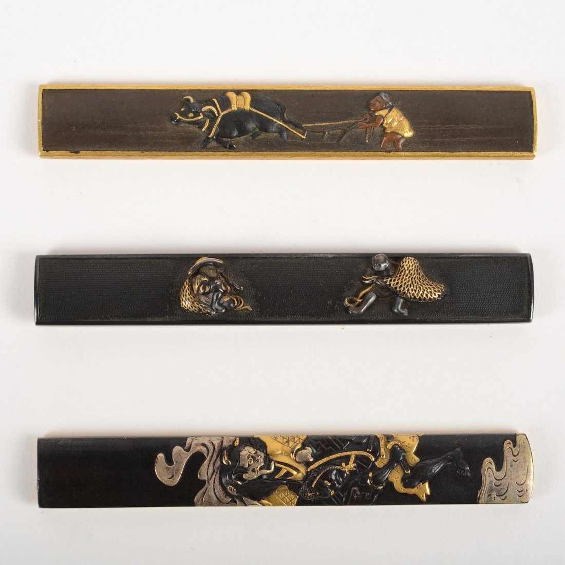 (3) Japanese Kozuka handles: (3) Japanese Kozuka handles, 19th c., two artist-signed, fishermen, farmer with ox and Hannya, 3.75"l (each)