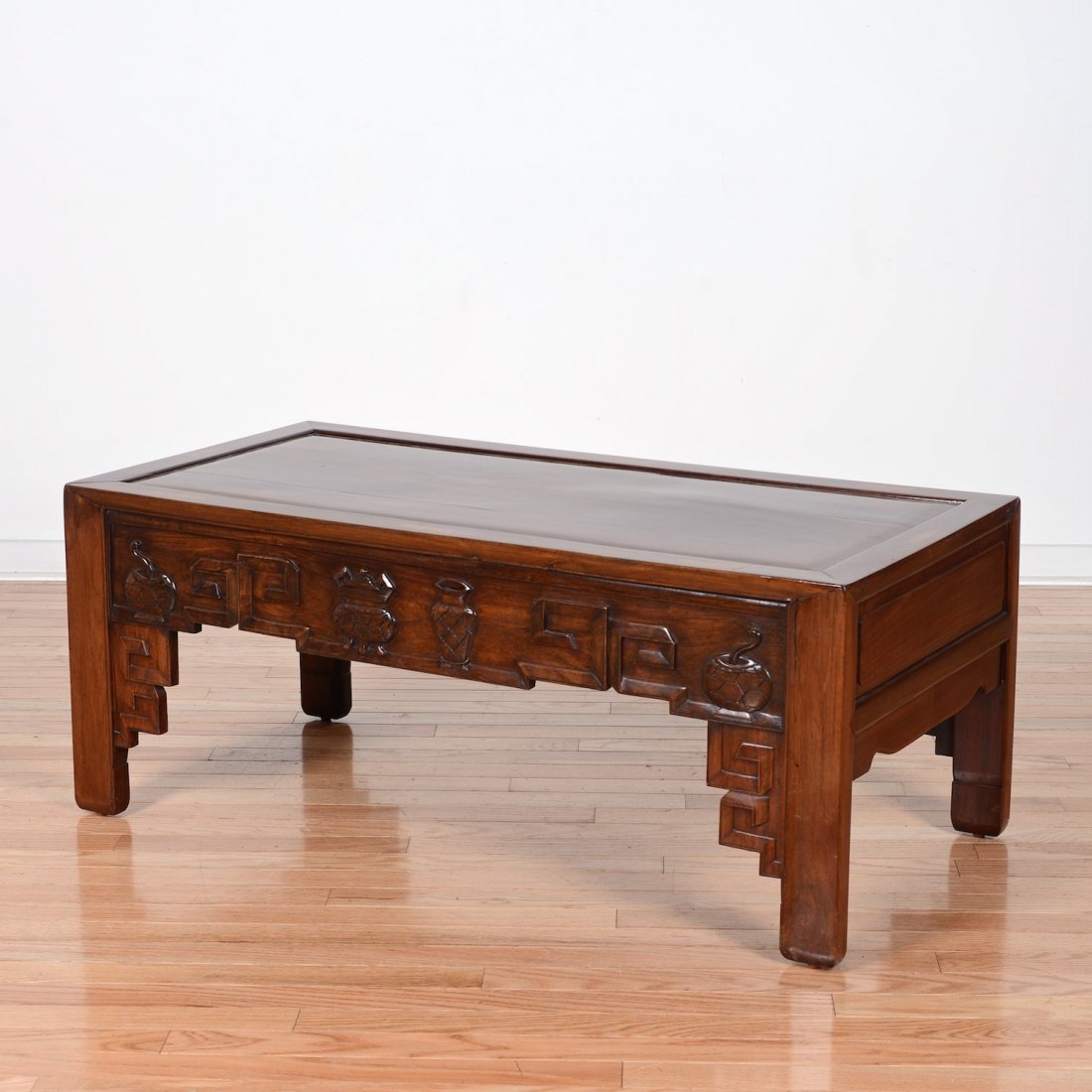 Chinese carved hardwood low table: Chinese carved hardwood low table, 19th/20th c., decorated with censer vessels, 16"h x 40"l x 19.5"w