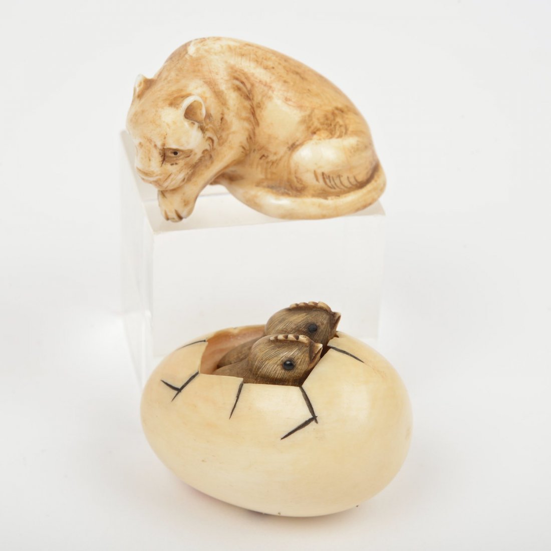 (2) Japanese ivory artist-signed netsuke: (2) Japanese ivory artist-signed netsuke, 19th/20th c., tiger and chicks in egg with inlaid eyes, 1"h x 1.5"w x 1"d and 1.25"h x 1.5"w x 1.25"d