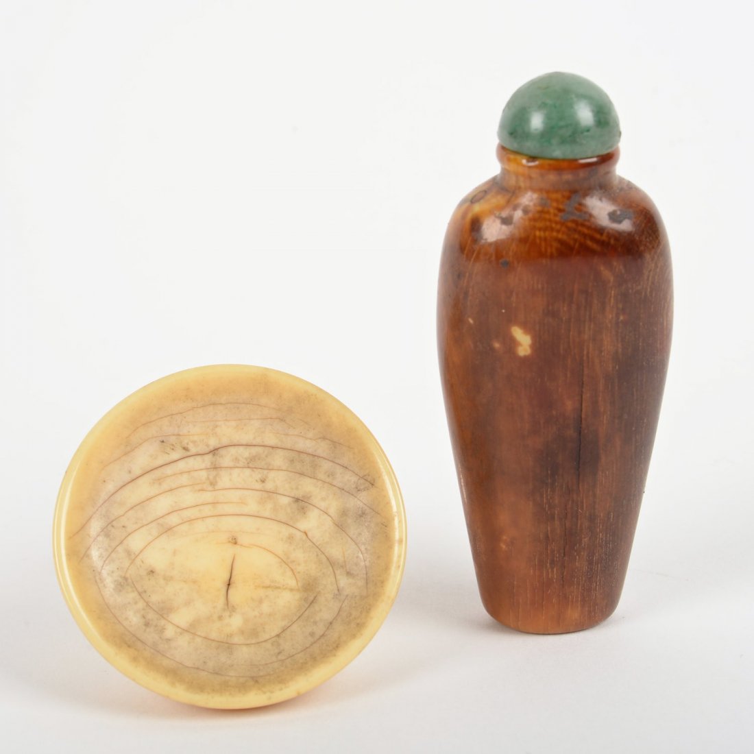 Chinese ivory snuff bottle and saucer: Chinese ivory snuff bottle and saucer, 18th/19th c., the bottle possibly mammoth ivory, green jade cap, 3"h x 1.25"w (bottle), 1.75"dia. (saucer)
