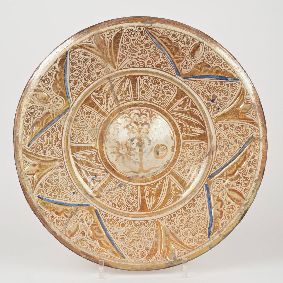 Hispano Moresque luster glazed earthenware charger: Hispano Moresque luster glazed earthenware charger, Possibly 16th/17th c., with central sun, moon and tree reserve, 19.75"dia.