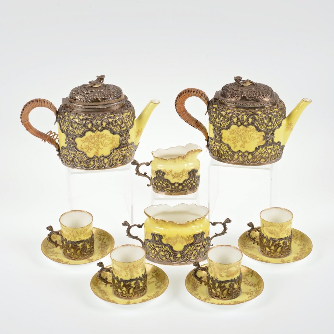 Crown Staffordshire silver overlay tea/coffee set: Crown Staffordshire silver overlay tea/coffee set, Circa 1900, the mounts probably by W. Comyns & Sons, yellow ground, (8) pcs., incl. (1) coffee teapot, (1) teapot, (1) sugar bowl, (1) creamer and (4