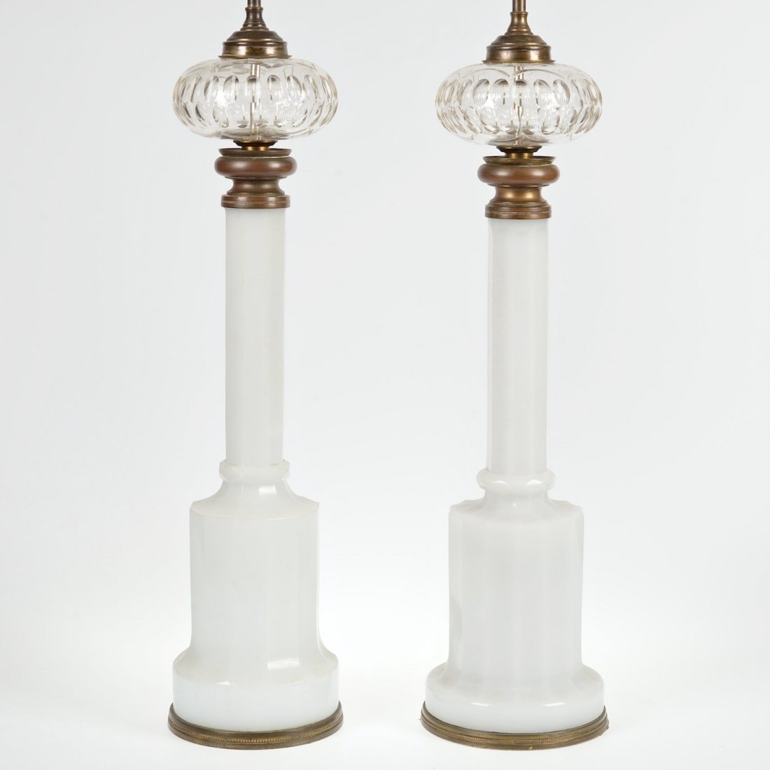 Pair Napoleon III white opaline glass banquet lamps: Pair Napoleon III white opaline glass banquet lamps, 19th c., bronze mounts, cut fonts, 24.5"h x 7"dia. (excl. lamp fittings), 39"h (total)