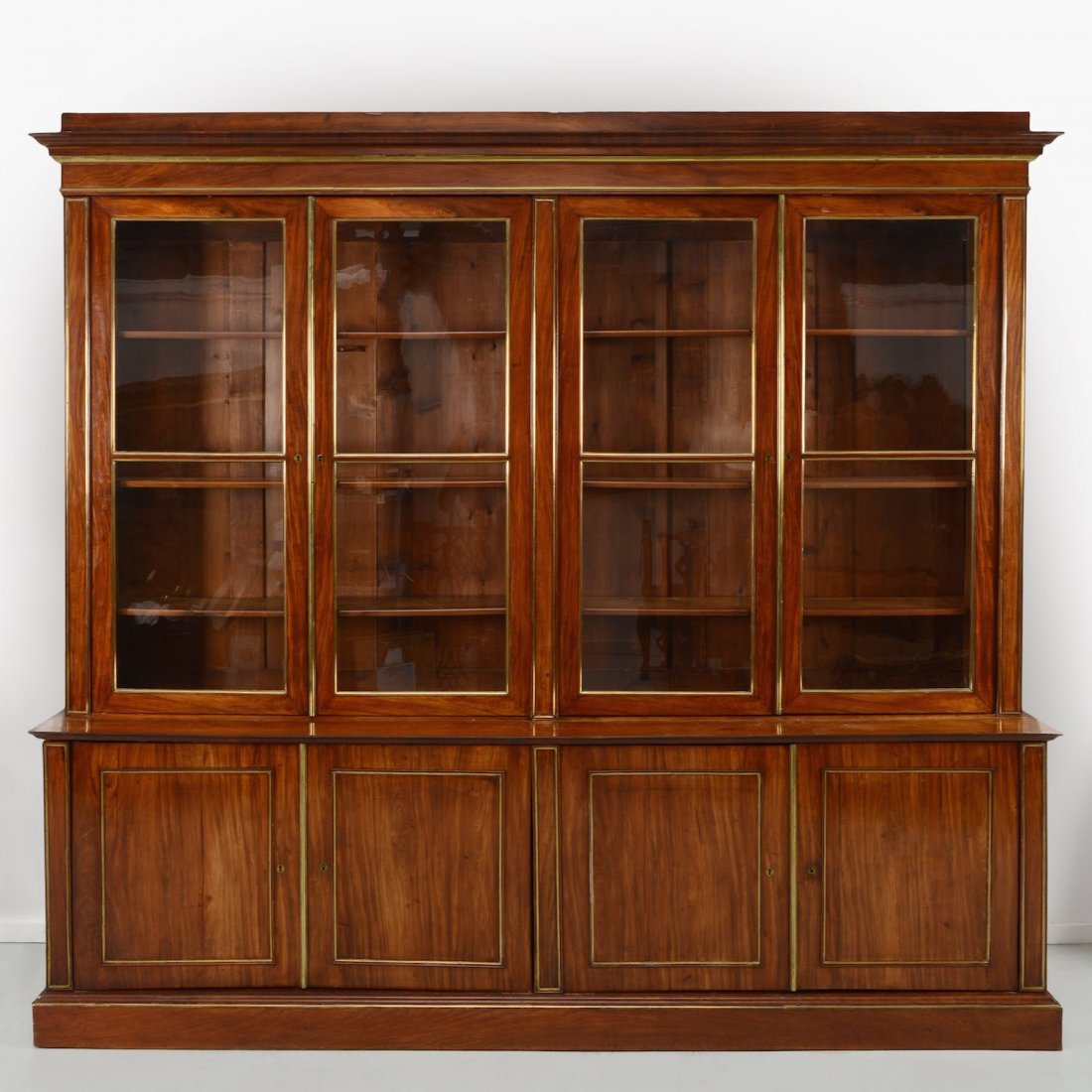 Large Louis XVI brass inlaid mahogany biblioteque: Large Louis XVI brass inlaid mahogany biblioteque, 18th/19th c., upper section with glazed panel doors enclosing shelves, 103.5"h x 114.5"l x 19"d Provenance: from the Estate of Edgar M. Bronfman, New