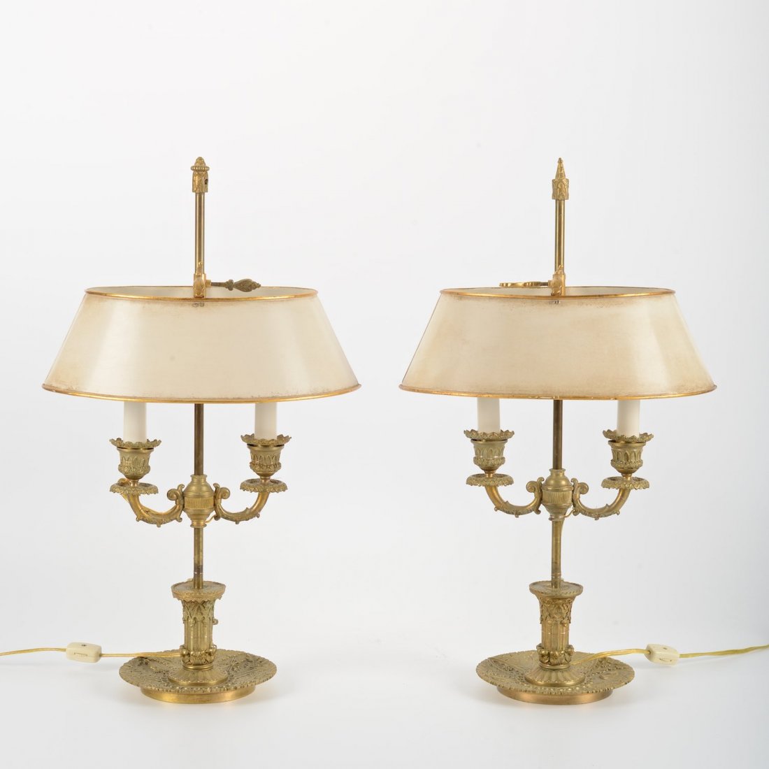 Nice pair Louis Philippe bronze bouillotte lamps: Nice pair Louis Philippe bronze bouillotte lamps, 19th c., white tole shades, hunt themed decoration, 21"h x 12.5"w x 9"d (total)