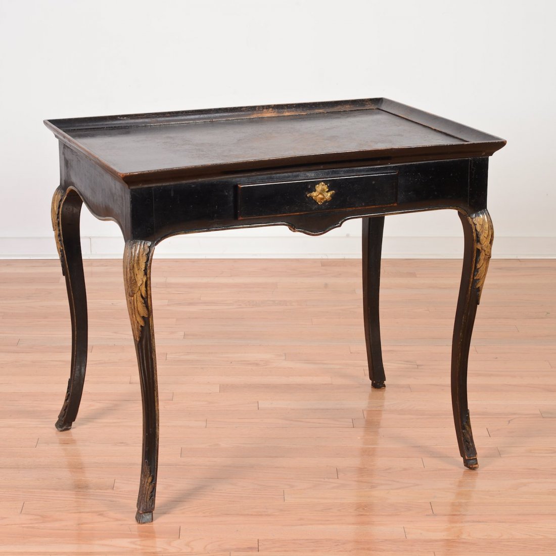 Louis XV style black lacquered petit bureau plat: Louis XV style black lacquered petit bureau plat, 19th c., parcel gilt foliate knee carving, 28"h x 32.25"w x 22.5"d Provenance: from the Estate of Edgar M. Bronfman, New York, NY