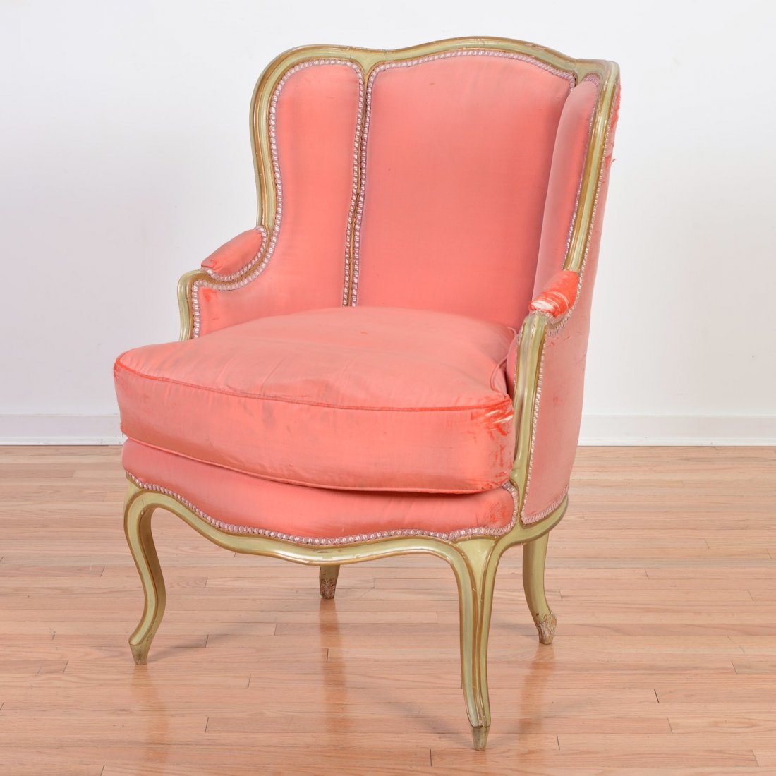 Louis XV style green painted bergere d'oreilles: Louis XV style green painted bergere d'oreilles, 19th c., coral silk upholstery, 38.5"h x 27"w x 23"d