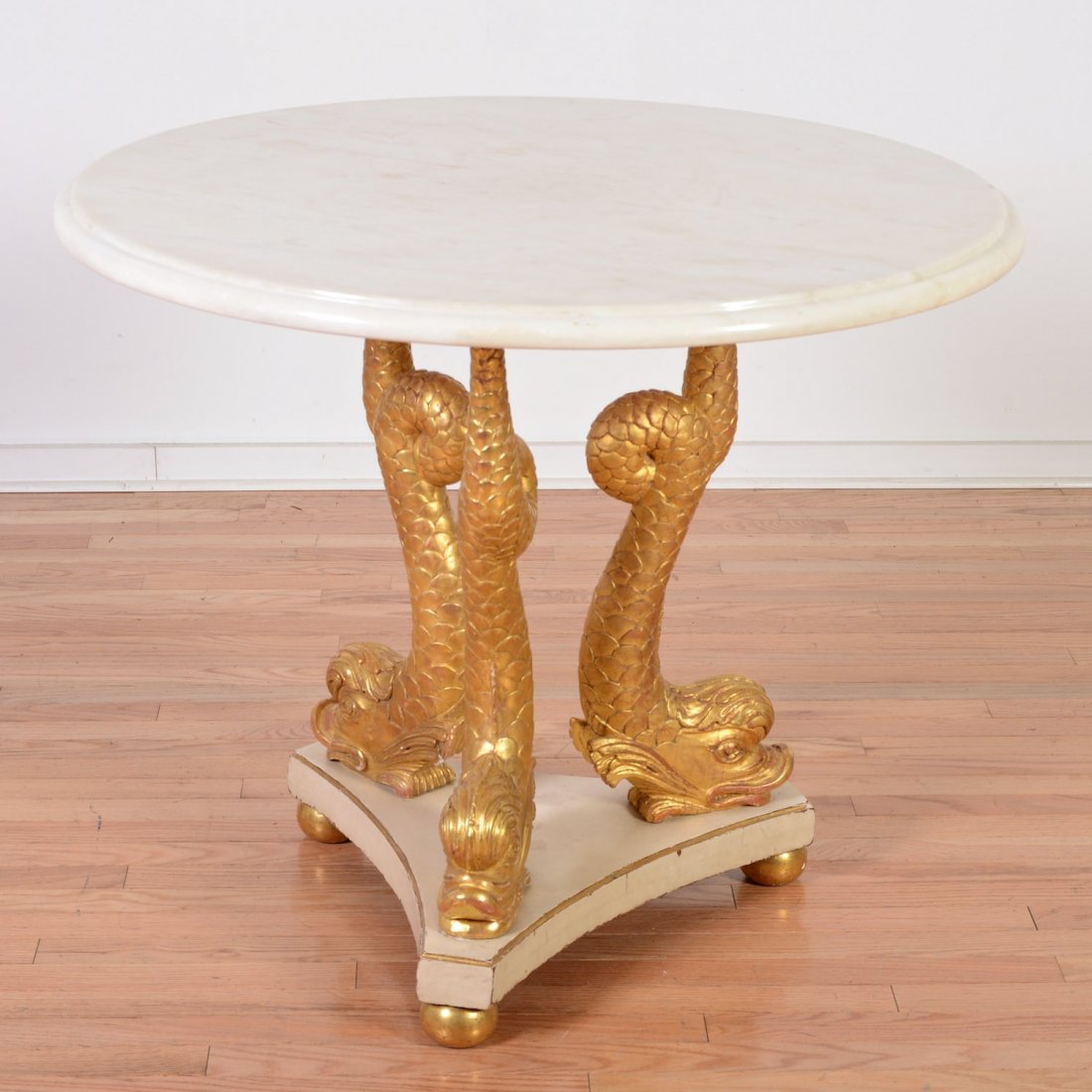 Italian Neo-Classical painted and giltwood center table: Italian Neo-Classical painted and giltwood center table, 19th/20th c., molded marble top, dolphin-form supports, 30.5"h x 36"dia. Provenance: from the Estate of Edgar M. Bronfman, New York, NY