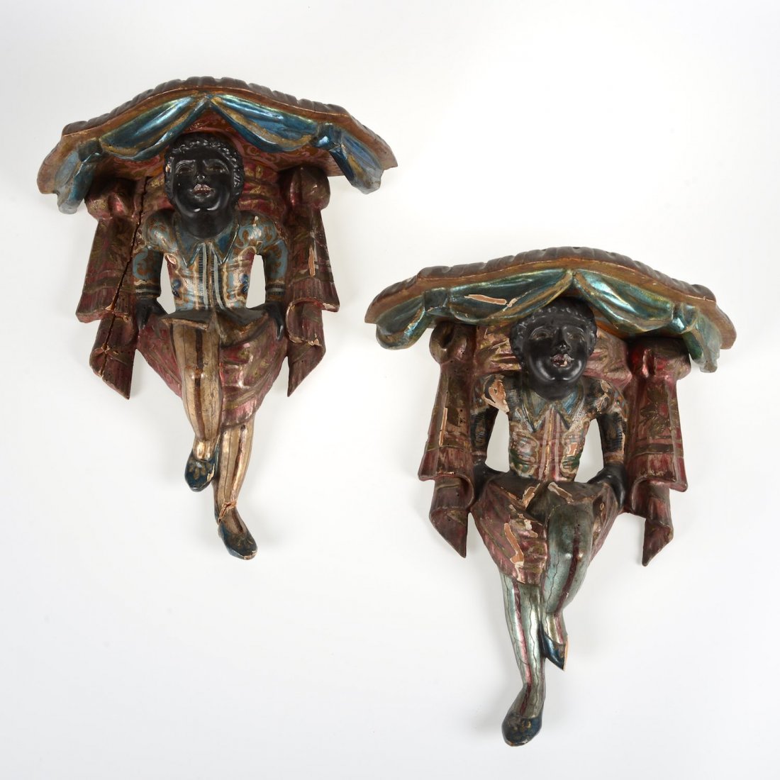 Pair Venetian polychromed wood blackamoor wall brackets: Pair Venetian polychromed wood blackamoor wall brackets, 19th c., drapery carved tops, 15"h x 13"w x 7.5"d