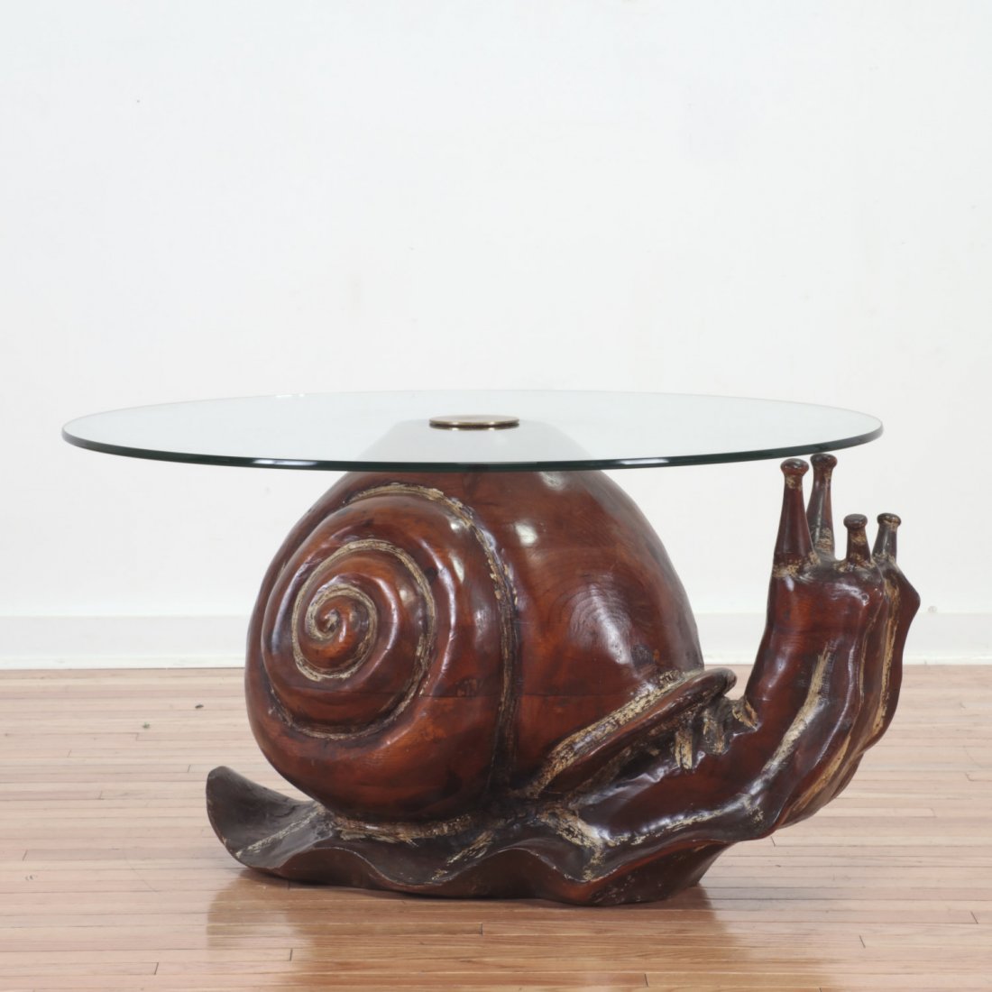Federico Armijo "Snail" coffee table: Federico Armijo "Snail" coffee table, Circa 1970s, carved wood, glass top with brass fitting, no signature found, 17.5"h x 32"dia.
