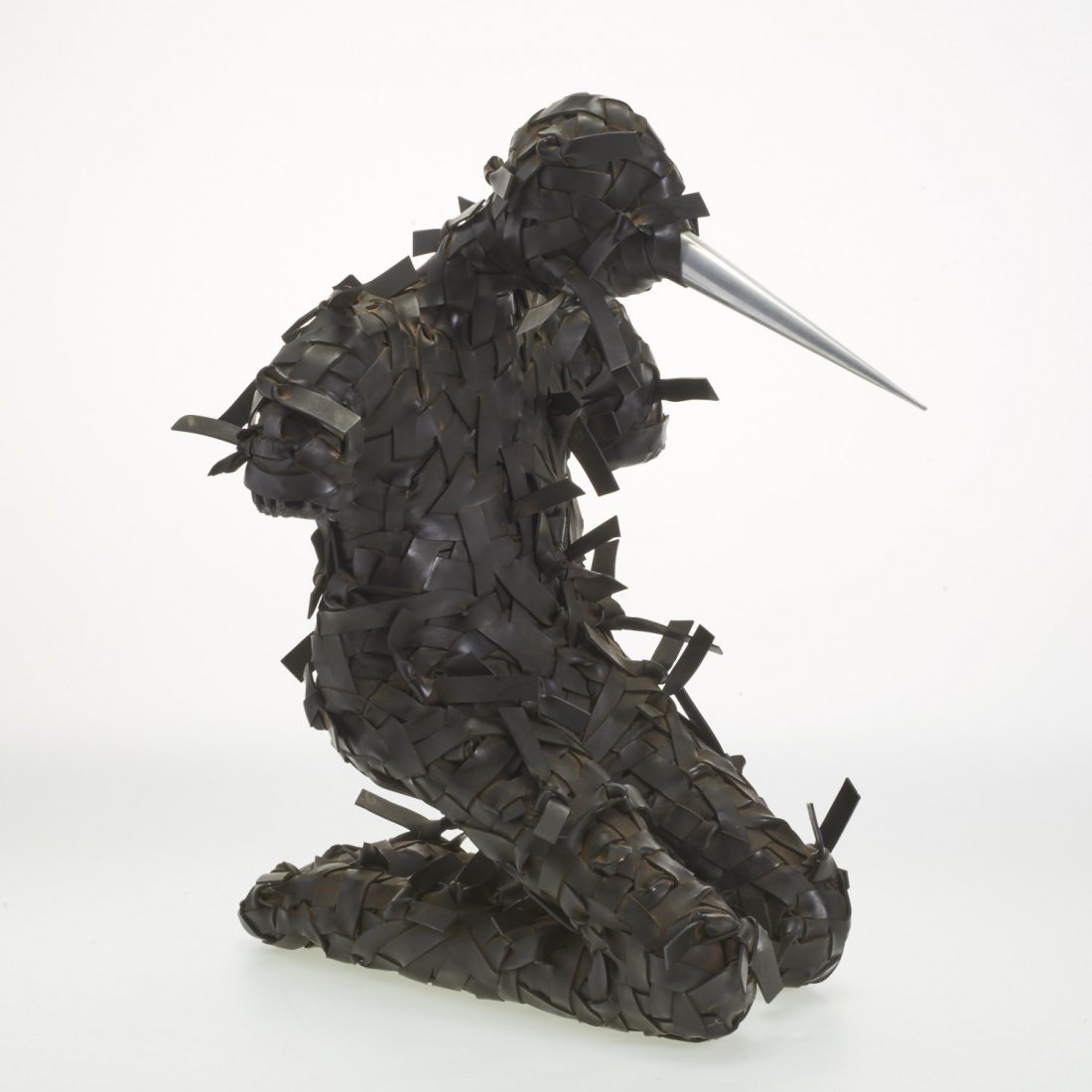 Manner of Chakaia Booker, rubber sculpture: Manner of Chakaia Booker, rubber sculpture, Manner of Chakaia Booker (American, 20th c.), kneeling horned figure, woven rubber strapping and aluminum, no signature found, 20"h x 15"w x 17.5"d