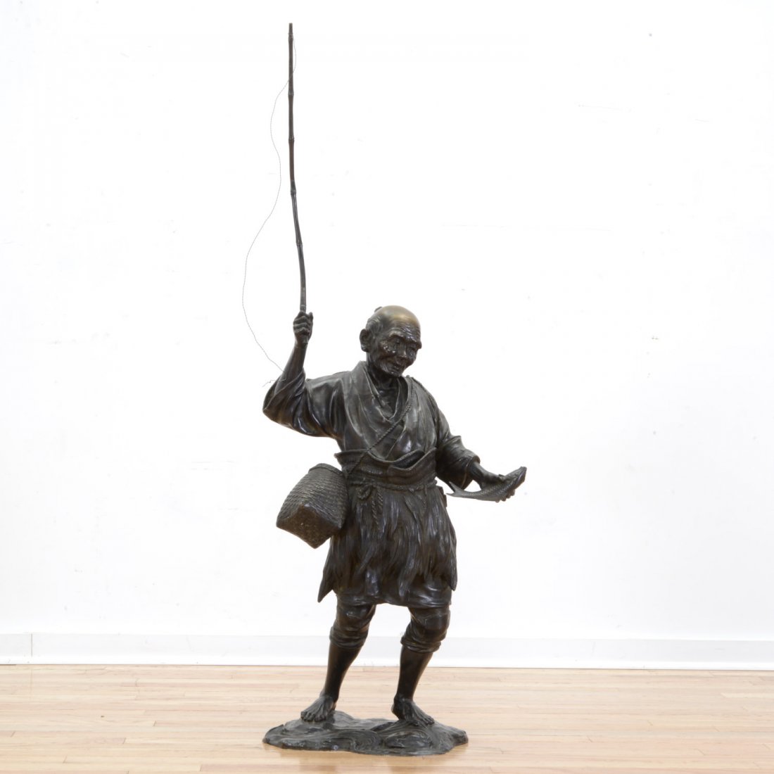 Genryusai Seiya, bronze: Genryusai Seiya, bronze, Genryusai Seiya (Japanese, 19th c.), circa 1890, Samurai fisherman, bronze with brown patina, Dai Nihon Genryusai Seiya zo seal mark to base, 47.5"h x 17"w x 11"d Provenance: 