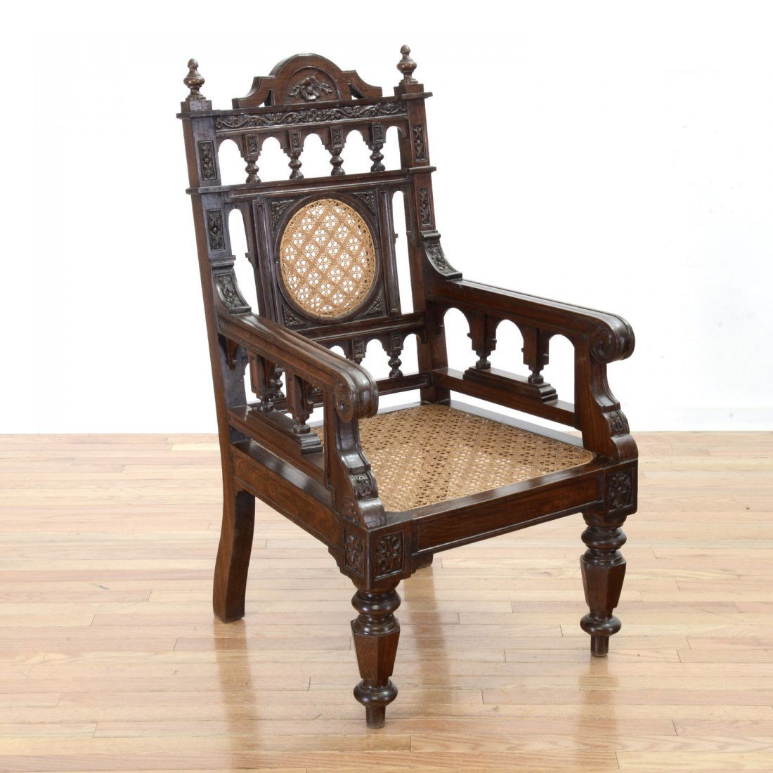 French Colonial rosewood armchair: French Colonial rosewood armchair, Circa 1870, with intricate hand carved and pierced splat, caned seat, turned legs, 46"h x 24.5"w x 23"d