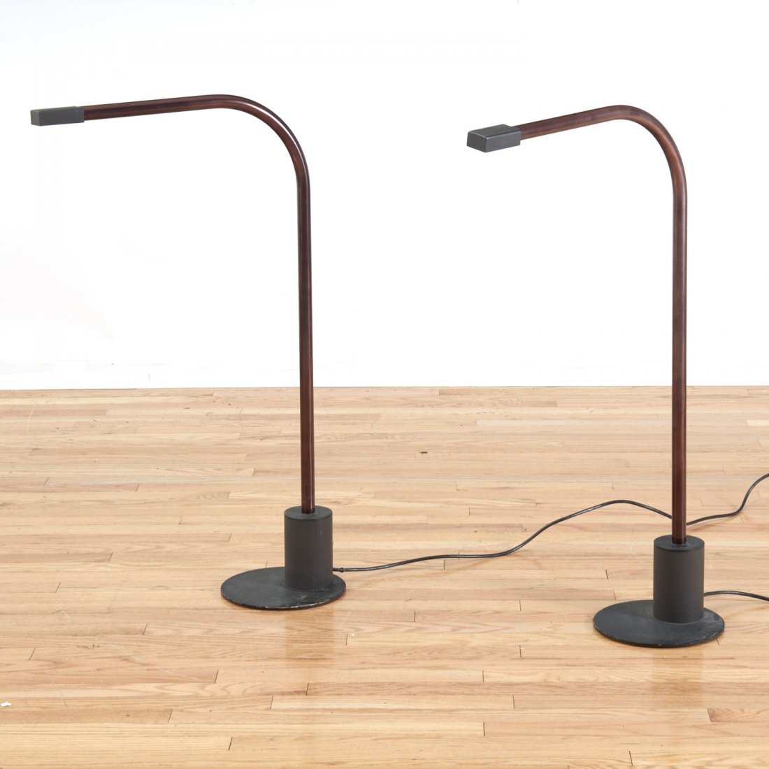 Pair Sonneman style anodized aluminum floor lamps: Pair Sonneman style anodized aluminum floor lamps, Circa 1970s, unmarked, brown finish with powder coated steel bases and foot switches, 37"h x 9"w x 19"d