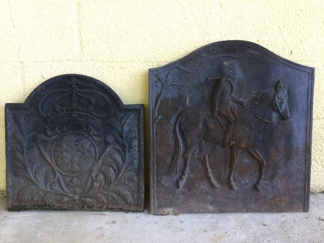 (2) antique and decorative cast iron firebacks: (2) antique and decorative cast iron firebacks, 19th c. and 20th c., 18.5"h x 18.5"w x .75"d and 22.75"h x 21.75"w x .75"d
