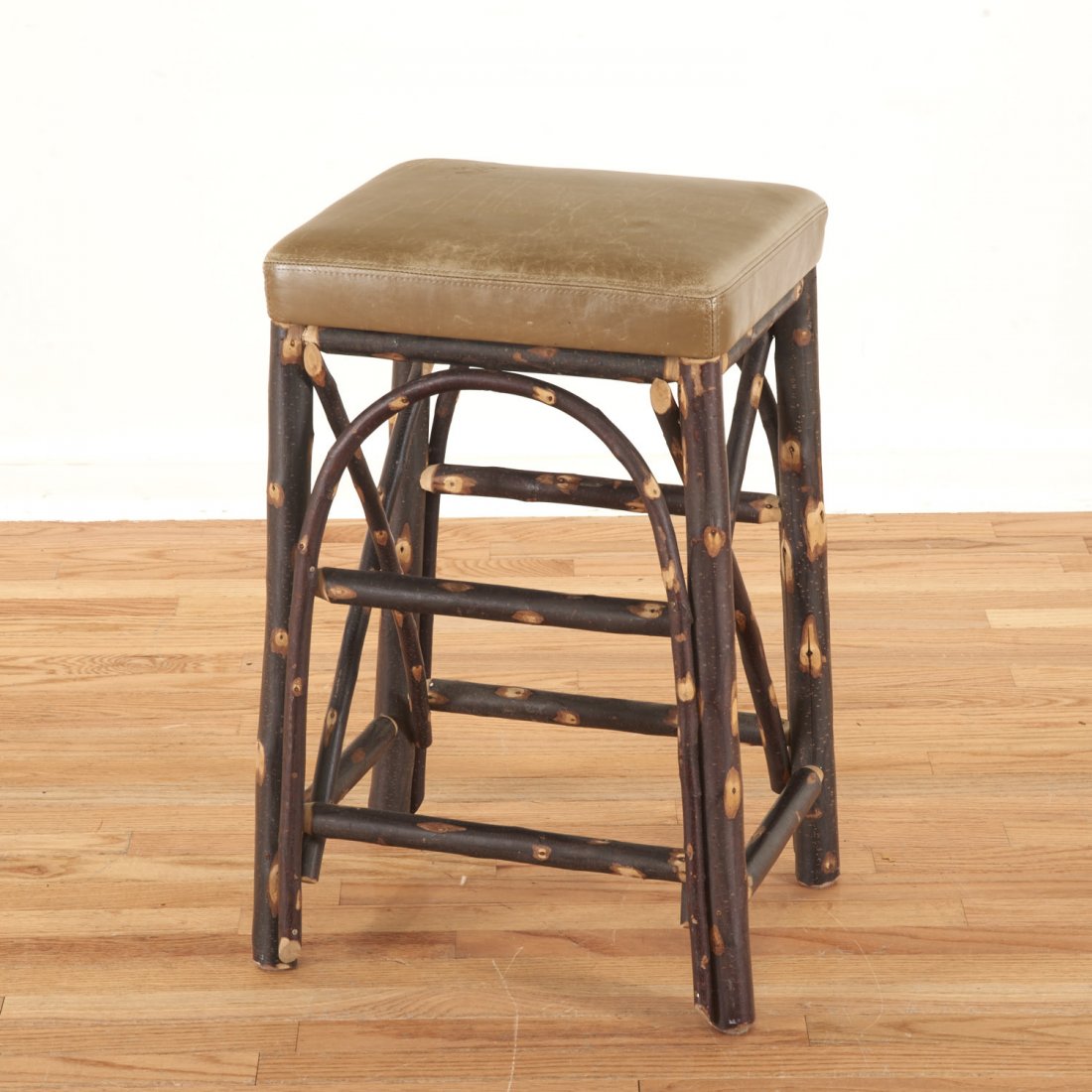 Christian Liaigre leather, chestnut stool: Christian Liaigre leather, chestnut stool, 21st c., "CHRISTIAN LIAIGRE HOLLY HUNT" label to underside, 24.75"h x 15.25"w x 13"d Provenance: Property from the Estate of a NY Financier