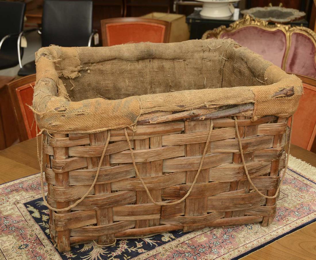 Antique burlap-lined basket: Antique burlap-lined basket, 19th c., painted "M" and "P" to sides, 15"h x 23"w x 18"d