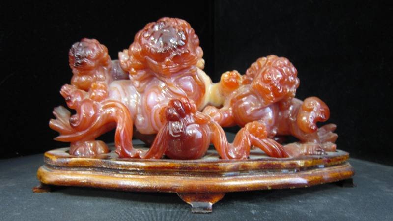 CARVED CHINESE CARNELIAN FOO LION GROUPING: CARVED CHINESE CARNELIAN FOO LION GROUPING Measures Approximately 6-1/2" Long by 3" Tall on Fitted Base. Weighs 434.2grams