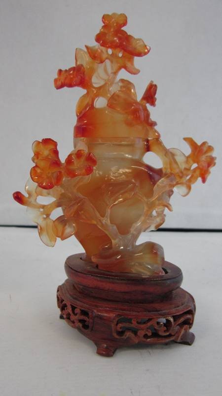 TWO CHINESE HARDSTONE CARNELIAN SCULPTURES: TWO CHINESE HARDSTONE CARNELIAN SCULPTURES One Depicting an Elder Holding a Staff 3" Tall and a Covered Jar 5" Tall, Plus 1-1/2" Footed Base. Mid 20th Century. Weighing 374.1grams