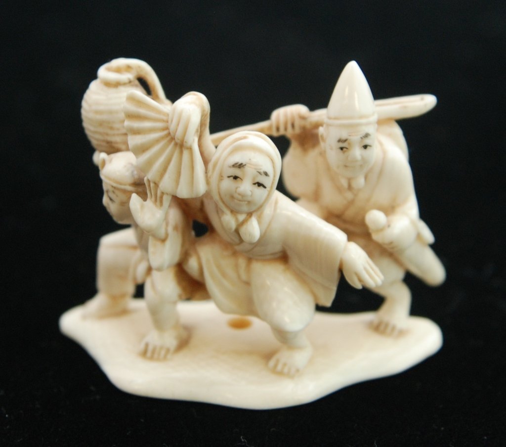 EXTRODINARY CHINESE IVORY NETSUKE CARVING: EXTRODINARY CHINESE IVORY NETSUKE CARVING Depicting Three Figures Working. Signed to Base n Black. Circa Early 20th Century. Measures Approximately 2" Long. Wild life Endangered Species Act laws must 