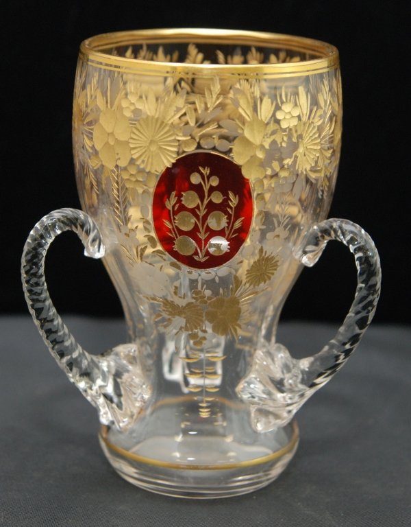 ANTIQUE MOSER LOVING CUP: ANTIQUE MOSER LOVING CUP Measures Approximately 4-1/4" Tall. Gold Enameled Paint, red Ovals with Three Applied Handles. Early to Mid 20th Century. Weighs 130gms