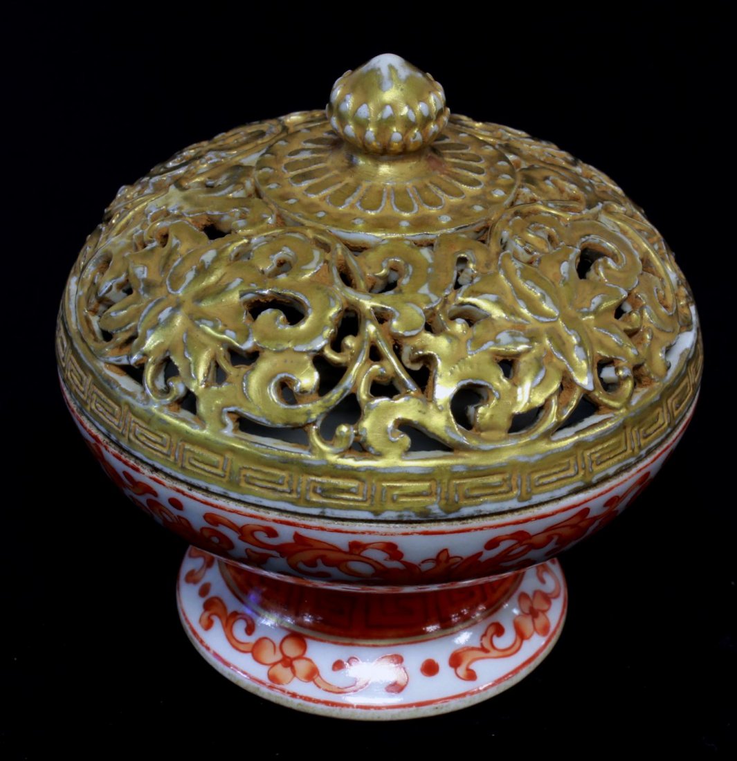 CHINESE COPPER RED RETICULATED INCENSE BURNER Chinese Q: Chinese Qing dynasty period iron red open work gilded floral incense burner. Bottom holds impressed reign marks. 18th/19th century. Measures 3 1/8" height x 3 1/4" diameter (7.9cm x 8.2cm).total weigh