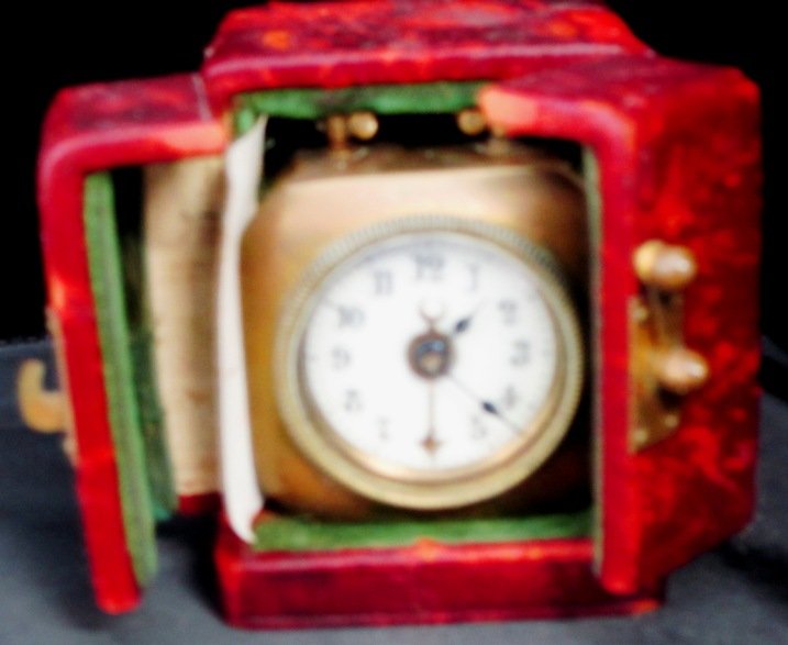 ANTIQUE GERMAN MINIATURE TRAVELING ALARM CLOCK: Approximately 2" Square. This Brass Clock is Signed Made in Germany. Comes with Original Leather Traveling Case. Has Porcelain Dial.