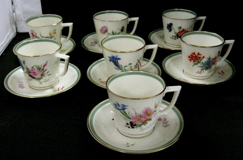SEVEN PIECE ROYAL COPPENHAGEN TEA CUP SAUCER SET: Royal Copenhagen china. Seven Piece Set of Cups and Saucers. The pattern features scattered floral with gold trimmed lid.The cup measures about 2.5" Tall.