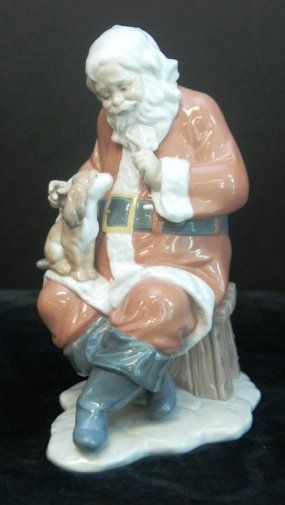 LLADRO SANTA'S LITTLE SECRET RETIRED 2013: Santa's Magical Workshop collection by Lladro brings the Christmas spirit back to life in your home. Santa Claus asks his pet dog to keep quiet while the elf and all children sleep. Measures 9" by 5" 