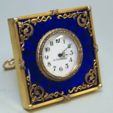 RUSSIAN GUILLOCHE SILVER ST PETERBOURG CLOCK: Russian Silver with Cobalt Blue Enameled After Faberge Clock. Diamonds around Bezel White Porcelain Face scroll design around frame. Measures 3" by 3" Weights 207 Grams