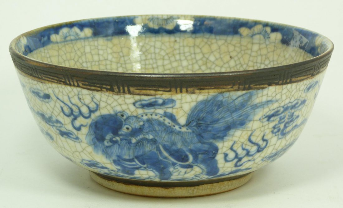 CHINESE BLUE & WHITE PORCELAIN FOO DOG BOWL: Chinese hand painted blue and white porcelain bowl depicting foo dogs amongst clouds and flames. 19th century. Measures 3 1/2" height x 8 1/8" diameter (8.9cm x 20.6cm). Total weight of 865 grams.