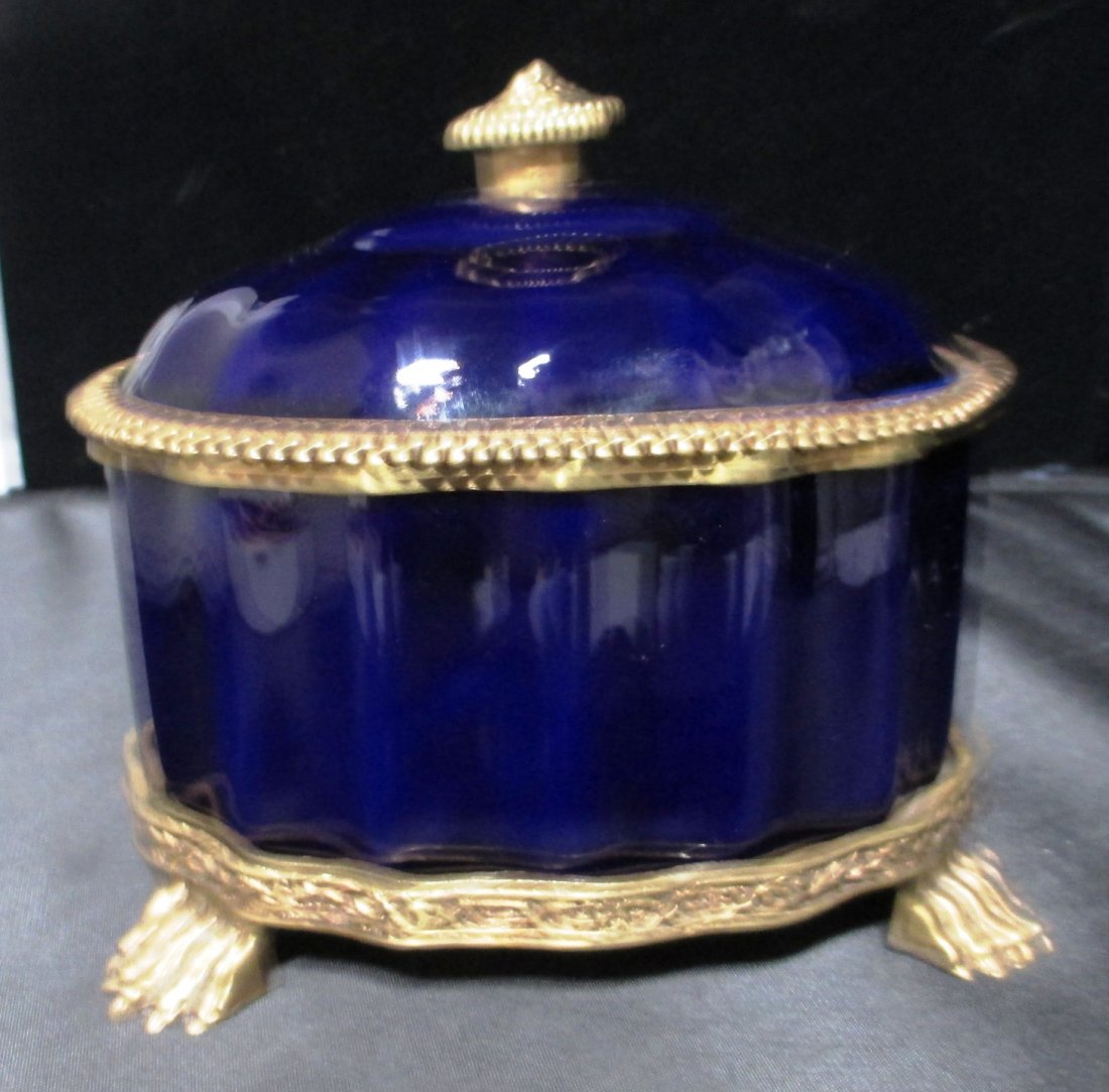 COBALT AND GOLD LIDDED JEWELRY BOX CLAW FEET Lidded: COBALT AND GOLD LIDDED JEWELRY BOX CLAW FEET Lidded Jewelry Box with Brass Accents. Claw Feet. Measures 7" Long by 5.5" Tall.