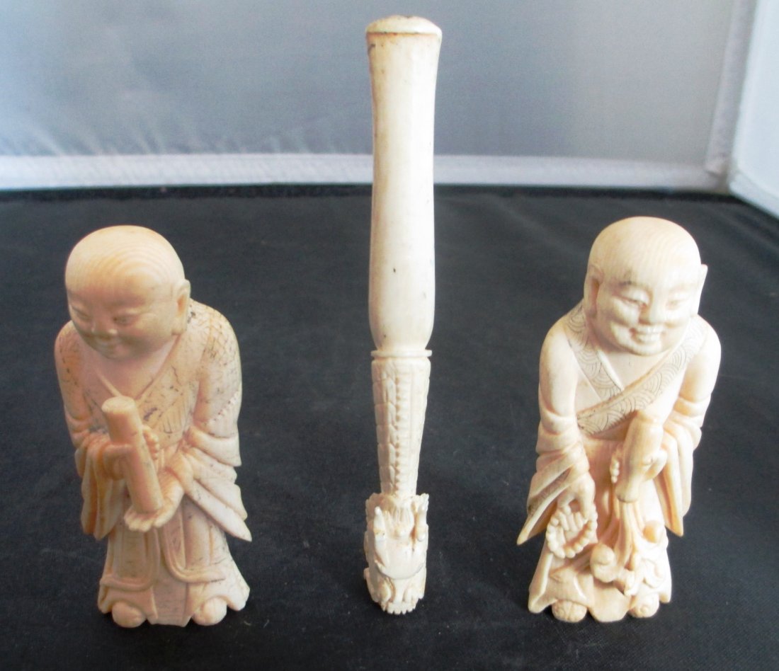 THREE IVORY FIGURES Two Buddhist Holy Men Measuring 3": Holy Men Measuring 3" Tall and Carved Dragon Cigarette Holder measuring 4 1/2" Long.
