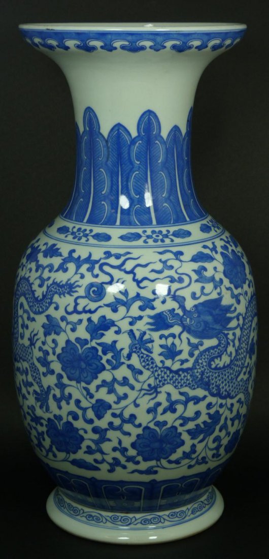 18th C CHINESE BLUE & WHITE PORCELAIN DRAGON VASE: Antique Chinese hand painted blue and white porcelain phoenix tail form vase depicting two flying dragons amongst lotus blossoms with scrolled vines. Flaming dragon jewels can also be seen. Bottom hol