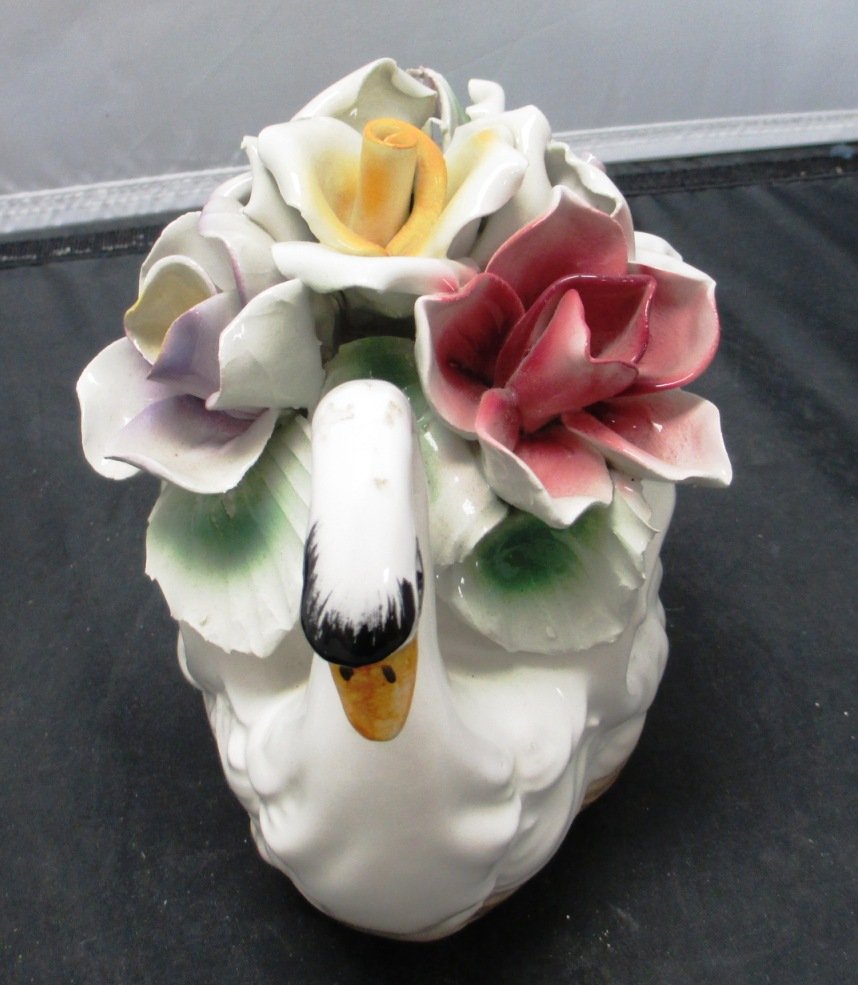 VINTAGE CAPODIMONTE PORCELAIN FLORAL SWAN: VINTAGE CAPODIMONTE PORCELAIN FLORAL SWAN vintage piece with amazing color and in great condition. She stands 7 1/2 " tall 10 1/2" long and 7" wide. The flowers are bright and vibrant and the swan ele