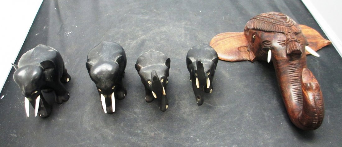 LOT OF 5 WOOD CARVED ELEPHANT GROUP: LOT OF 5 WOOD CARVED ELEPHANT GROUP Pair of Elephants with Trunk Down measures 3" Tall, Pair of Elephant with Trunks Up measures 4" Tall and Wall Plaque Elephant Head Trunk pointed up measures 7 1/2' 