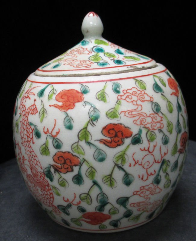 CHINESE PORCELAIN FLORAL DESIGN GINGER JAR: Foliage design throughout this covered ginger jar. Calligraphy marking on bottom Measures 6" (15 cm) height. Weighs 563.8 grams.