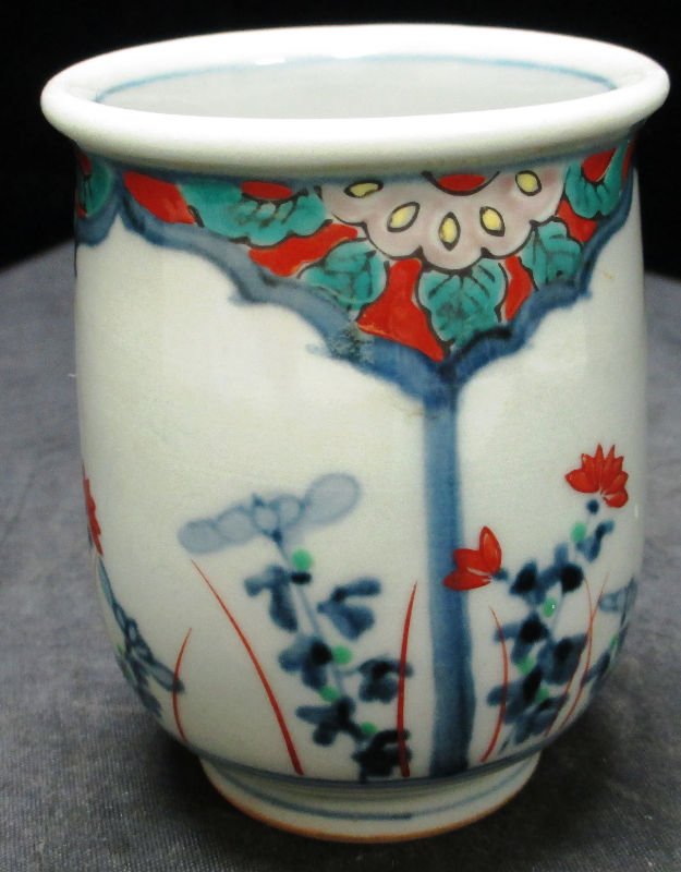 CHINESE PORCELAIN CUP: CHINESE PORCELAIN CUP Depicting floral blue and white scene with enamel decoration. Chinese calligraphy marking on bottom. Measures 3 1/4" (8 cm) height. Weighs 130.1 grams.