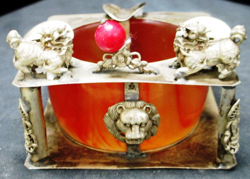 TIBETAN SILVER AND PORCELAIN ASHTRAY: TIBETAN SILVER AND PORCELAIN ASHTRAY Porcelain and Silver Ashtray with Foo Dogs and Lion Head. Measures 3" Tall and 3 1/2" Squared.