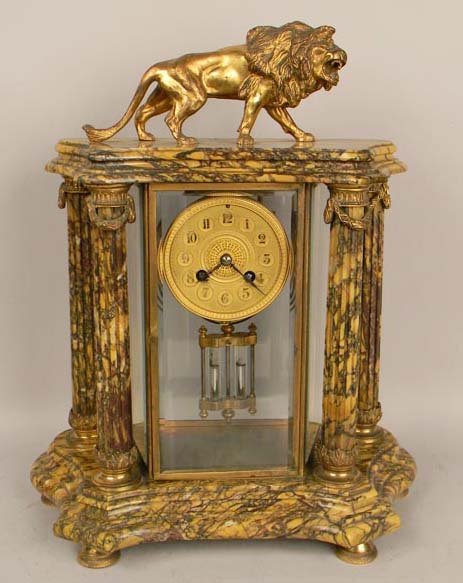 FRENCH ANTIQUE 1880'S MARBLE CLOCK WITH BRONZE LION: French 1880's marble clock with a bronze lion statue on top. All four glasses are original and beveled.