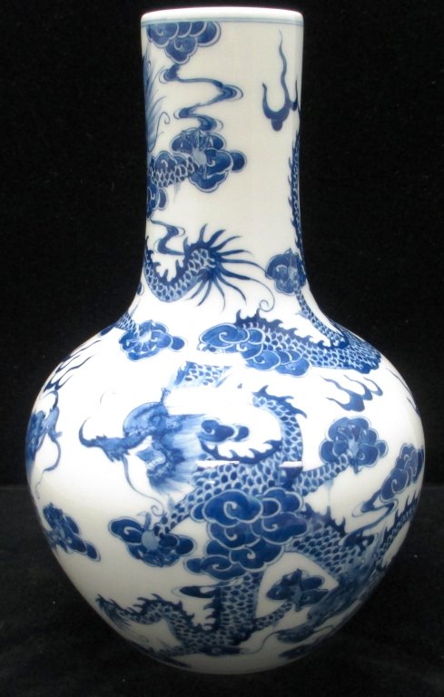CHINESE PORCELAIN QING DYNASTY DRAGON VASE: Blue and White Porcelain Vase. Bears the Qing Dynasty mark on Bottom. 5 Dragon Vase. Measures 9 3/4" Tall.