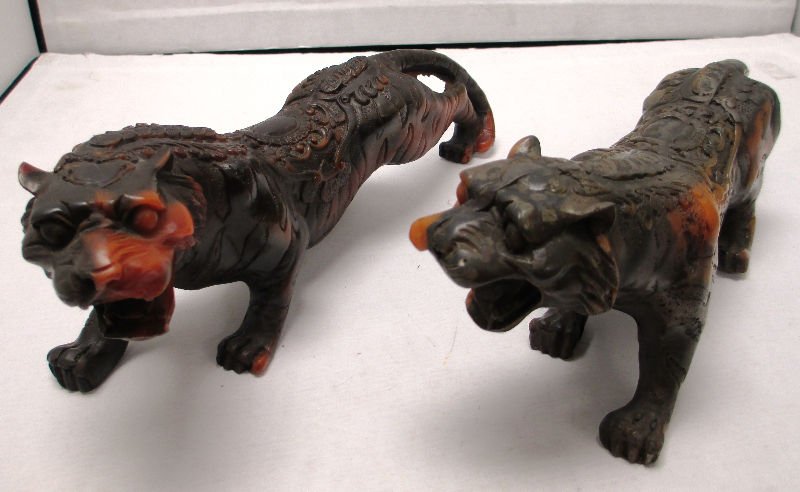 PAIR OF CHINESE COMPOSITE CARVED TIGERS Intricately: Intricately carved Composite Tigers with Buddhist Symbols. Each Tiger measures 10" Long, and is in Hunting position.